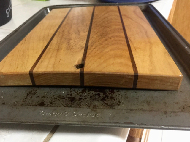 Warped wooden cutting board about to be fixed.
